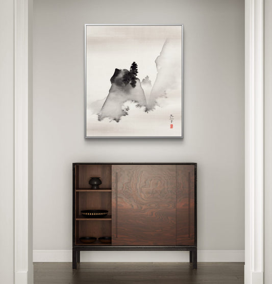 Framed artwork on a wall above a wooden cabinet