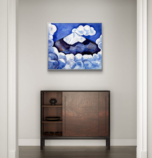 Abstract painting of a mountain and clouds above a wooden cabinet.