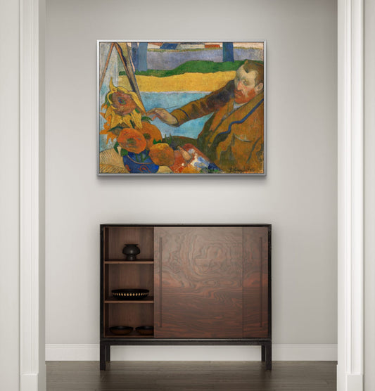 Framed painting of a child with sunflowers above a wooden cabinet.