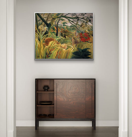 Framed artwork of a jungle scene above a wooden cabinet.