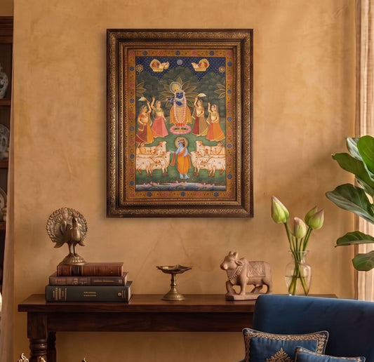 Decorative wall art with religious theme on a beige wall, with a table and decorative items below.