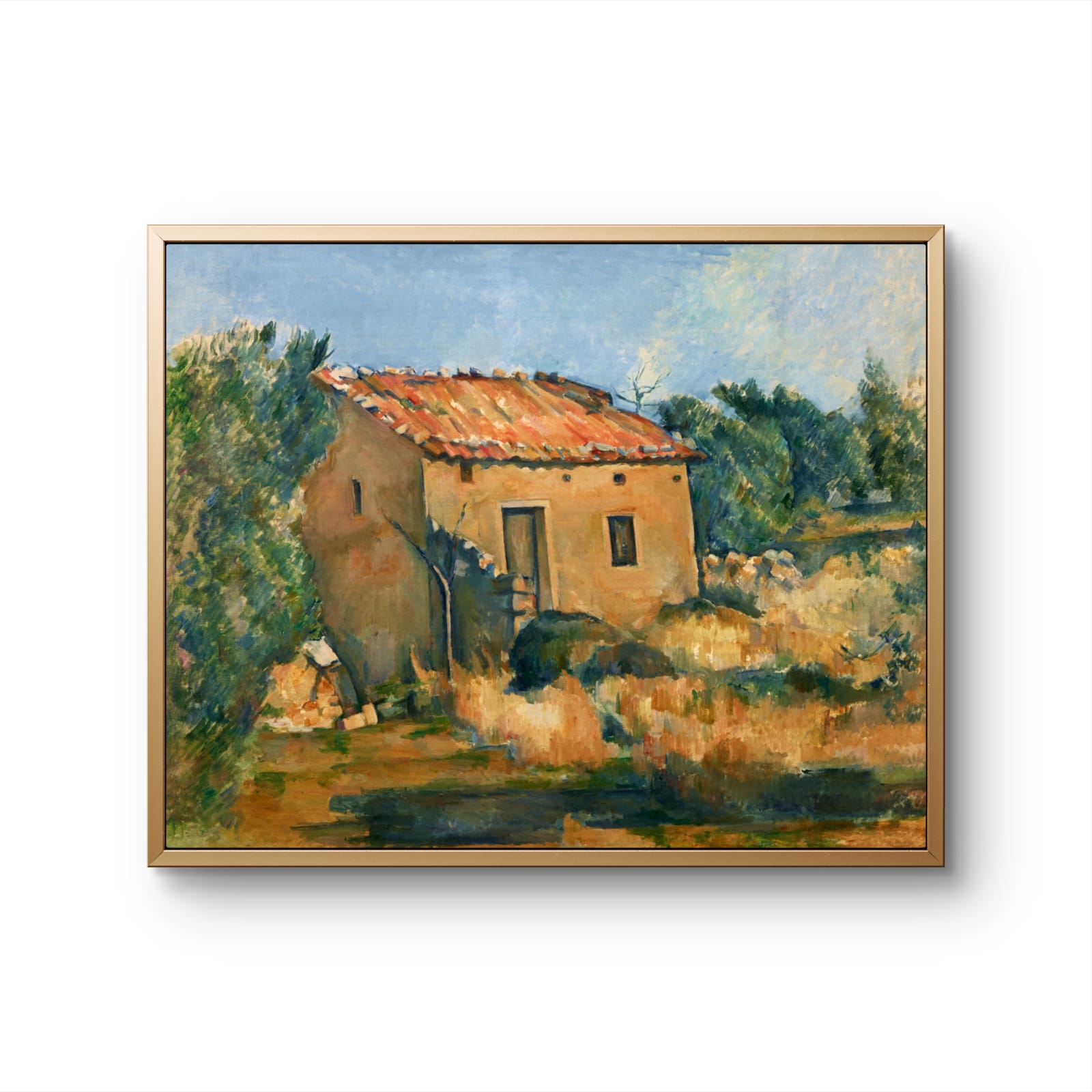 Framed painting of a rustic building with a landscape in the background