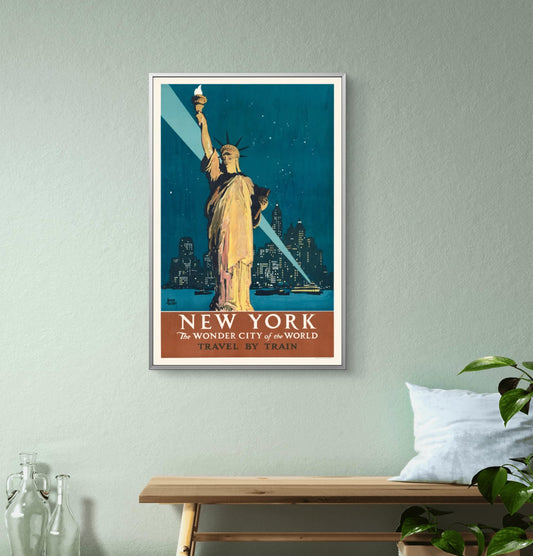 Framed poster of the Statue of Liberty on a wall above a wooden bench.