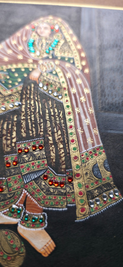 Decorative piece with intricate patterns and embellishments on a dark background