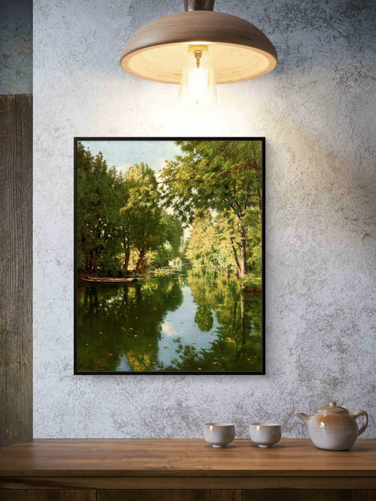 Framed nature print of a lake surrounded by trees on a textured wall above a wooden table with teacups and a teapot.