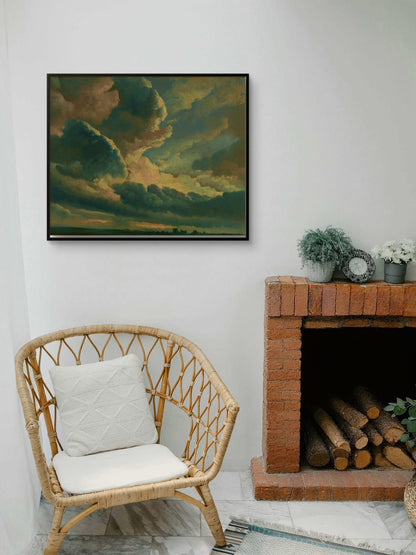 Living room with a wicker chair, fireplace, and framed artwork of a sunset.